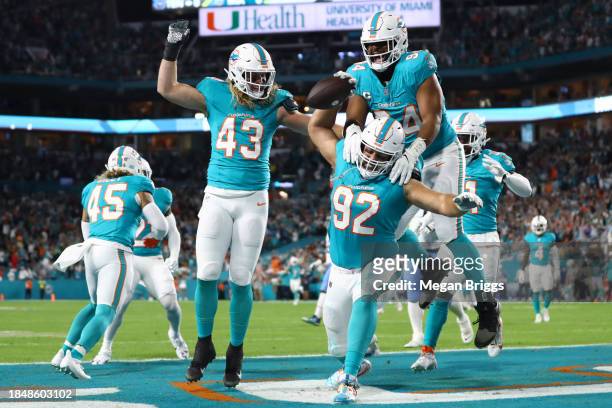 Andrew Van Ginkel, Zach Sieler and Christian Wilkins of the Miami Dolphins celebrate after a fumble recovery touchdown in the first quarter against...