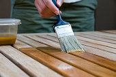 Woman Applying Stain to Wood