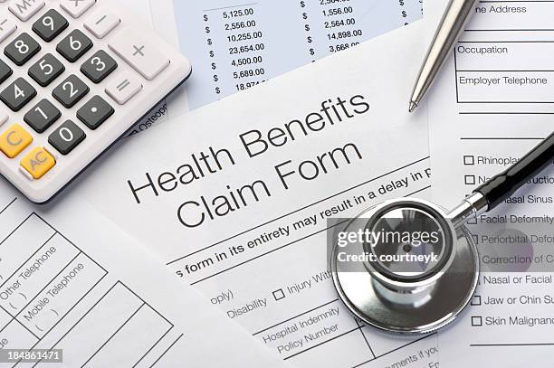 close up a health benefits claim form - reimbursement stock pictures, royalty-free photos & images
