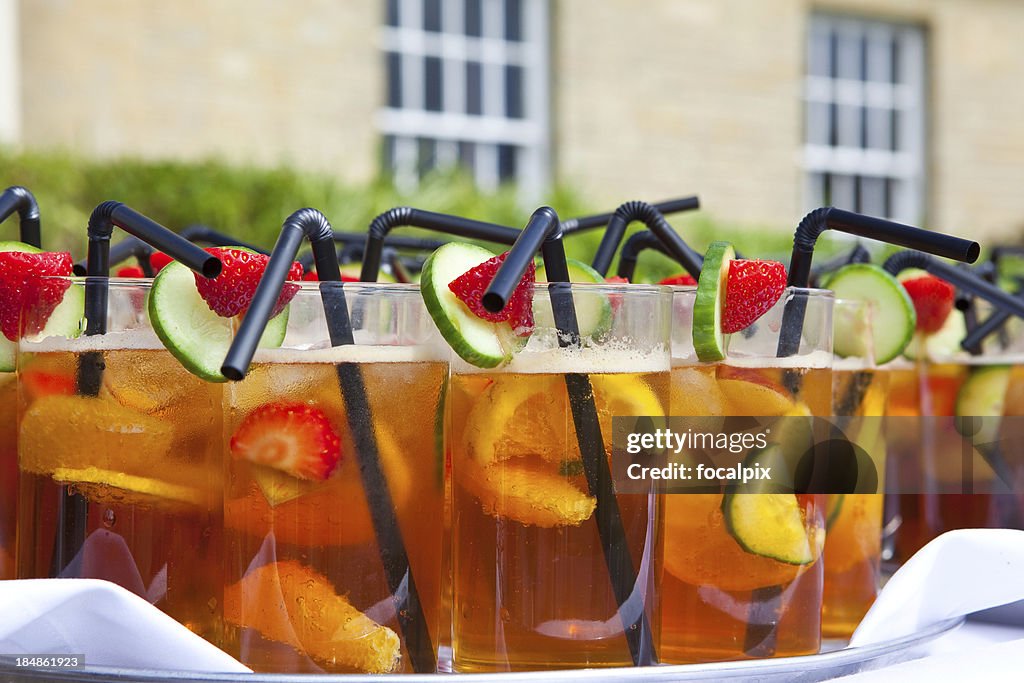 Glasses of Summer Cup on white tablecloth at garden party