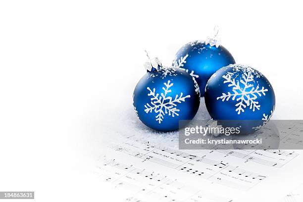 blue baubles on sheet notes with christmas carols - christmas music stock pictures, royalty-free photos & images