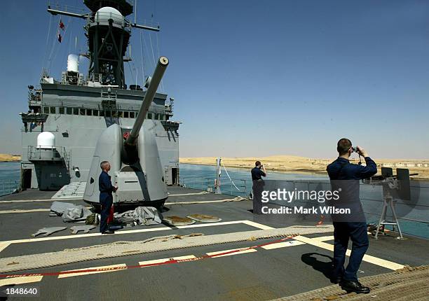 Sailors take in the view while traveling through the Suez Canal March 14, 2003 aboard the destroyer USS Deyo. The Deyo is traveling through the canal...