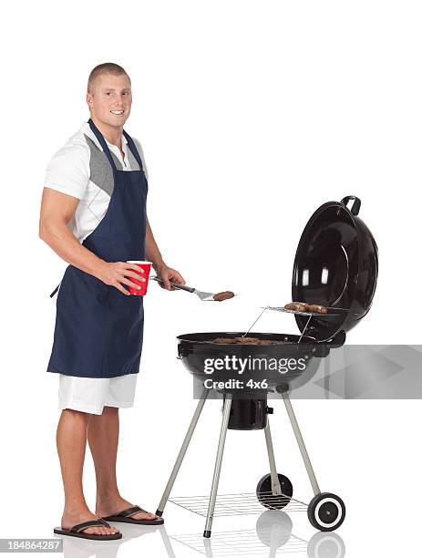 man cooking on a barbecue grill - apron isolated stockfoto's en -beelden