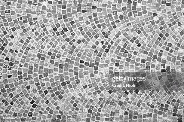 a close-up view of a cobbled stone road - cobblestone stock pictures, royalty-free photos & images