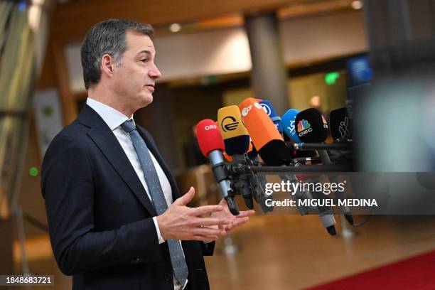 Belgium's Prime Minister, Alexander De Croo speaks to the press as he arrives at the European headquarters to attend the European Union summit, in...