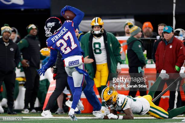 Jason Pinnock of the New York Giants intercepts a pass thrown by Jordan Love of the Green Bay Packers during the second quarter in the game at...