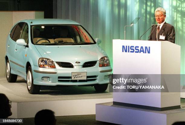 Yoshikazu Hanawa , president of Japan's automaker Nissan Motor Co. Ltd., unveils its new wagon "Tino" at a press preview at a Tokyo hotel 22...