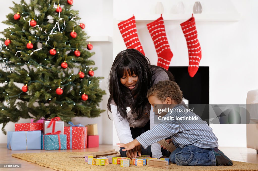 Toddler and Mother Playing With Building Blocks At Christmas