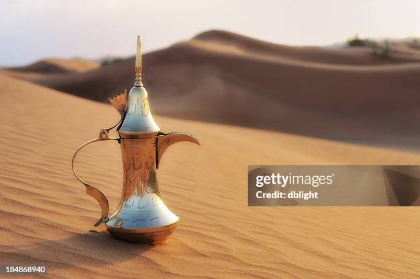 arabic styled coffee pot in the desert - coffee pot stock pictures, royalty-free photos & images