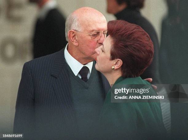Former apartheid-era President P.W. Botha kisses his daughter Elanza Maritz as they leave the Magistrate's Court in George at the end of the session...