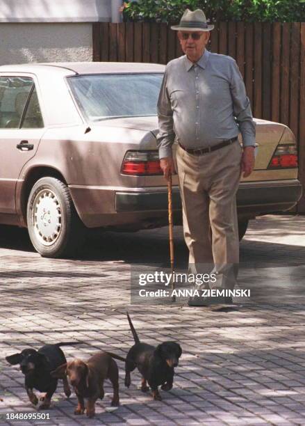 Former apartheid president Pieter Botha pose for photographers with his dogs 22 January in his somptuous property, "Die Anker", on the banks of the...