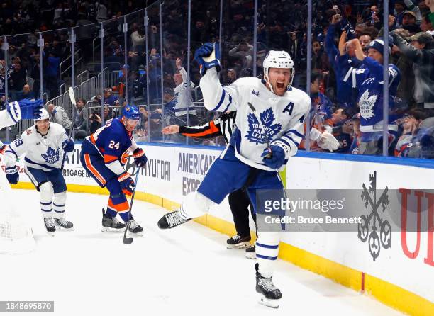 Morgan Rielly of the Toronto Maple Leafs scores at 19:53 of the third period against the New York Islanders at UBS Arena on December 11, 2023 in...