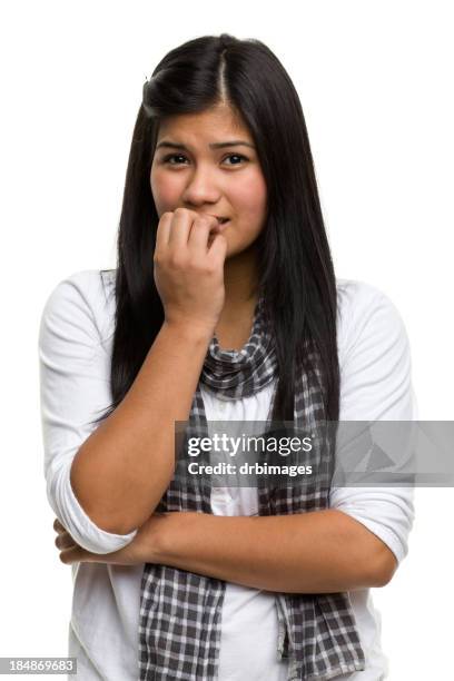 a young woman nervously biting her nails - girl ashamed stock pictures, royalty-free photos & images