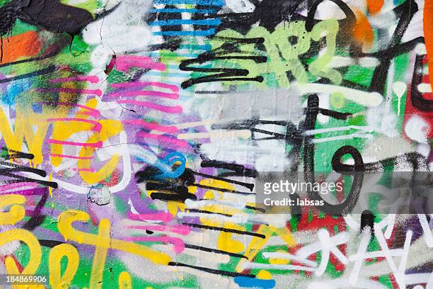 detail of graffiti painted illegally on public wall. - spray paint stock pictures, royalty-free photos & images