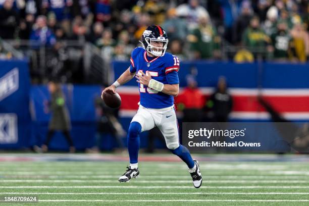 Tommy DeVito of the New York Giants scrambles and runs with the ball during an NFL football game between the New York Giants and the Green Bay...
