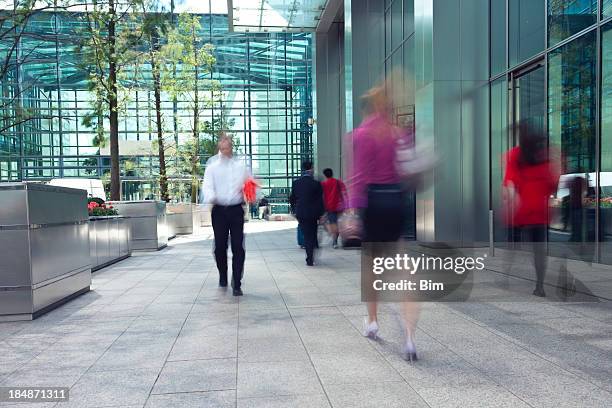 motion blur photo of people in financial district - female streaking stockfoto's en -beelden