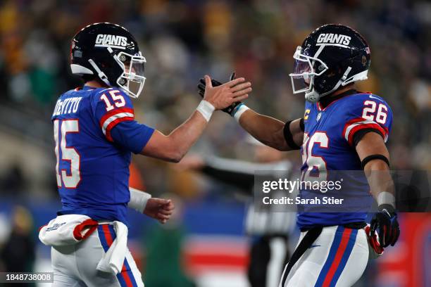 Saquon Barkley of the New York Giants celebrates with Tommy DeVito after scoring a touchdown against the Green Bay Packers during the third quarter...