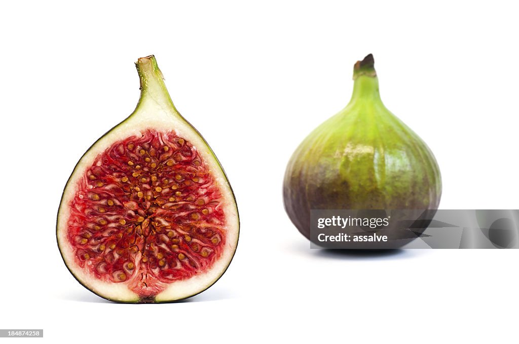 Bisected and whole fig fruit isolated on white