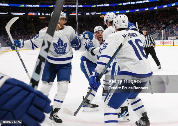 John Tavares of the Toronto Maple Leafs celebrates his assist and 1000th NHL point against the New York Islanders during the third period at UBS...