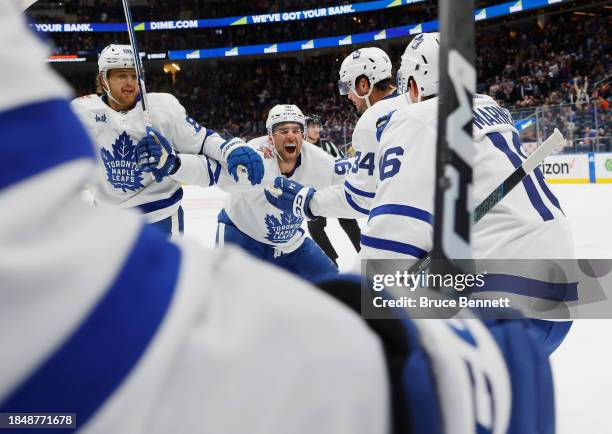 John Tavares of the Toronto Maple Leafs celebrates his assist and 1000th NHL point against the New York Islanders during the third period at UBS...