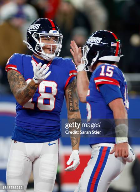 Isaiah Hodgins of the New York Giants celebrates with Tommy DeVito after scoring a touchdown against the Green Bay Packers during the third quarter...