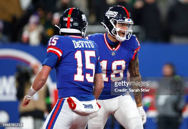 Isaiah Hodgins of the New York Giants celebrates with Tommy DeVito after scoring a touchdown against the Green Bay Packers during the third quarter...