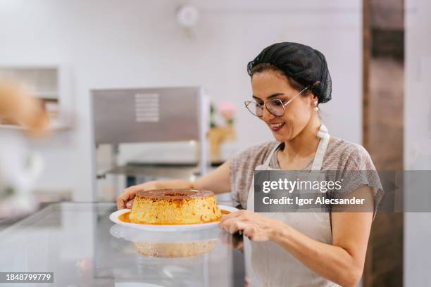 pastry shop owner holding a milk pudding - confectioner stock pictures, royalty-free photos & images