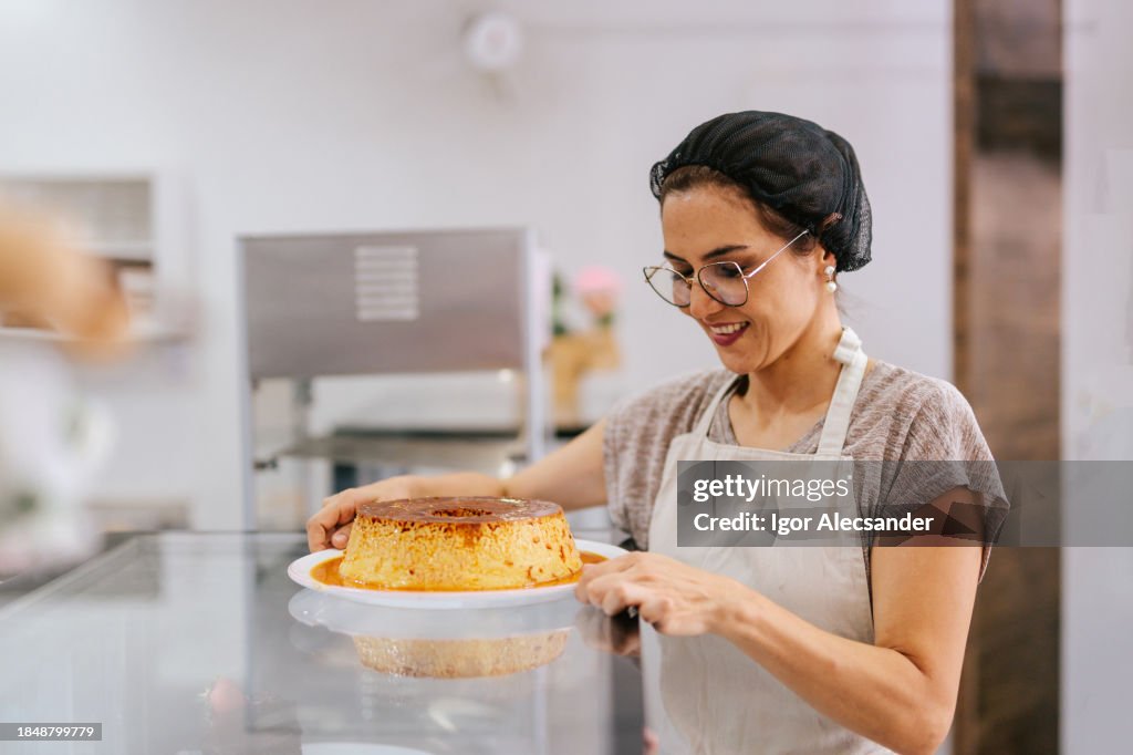 Pastry shop owner holding a milk pudding