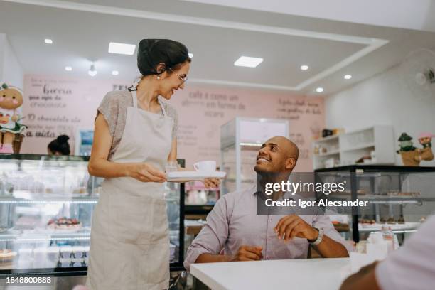 waitress delivering customer order in cafe - sweet shop stock pictures, royalty-free photos & images