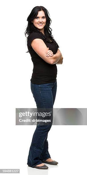 standing young woman with arms crossed - zwarte spijkerbroek stockfoto's en -beelden