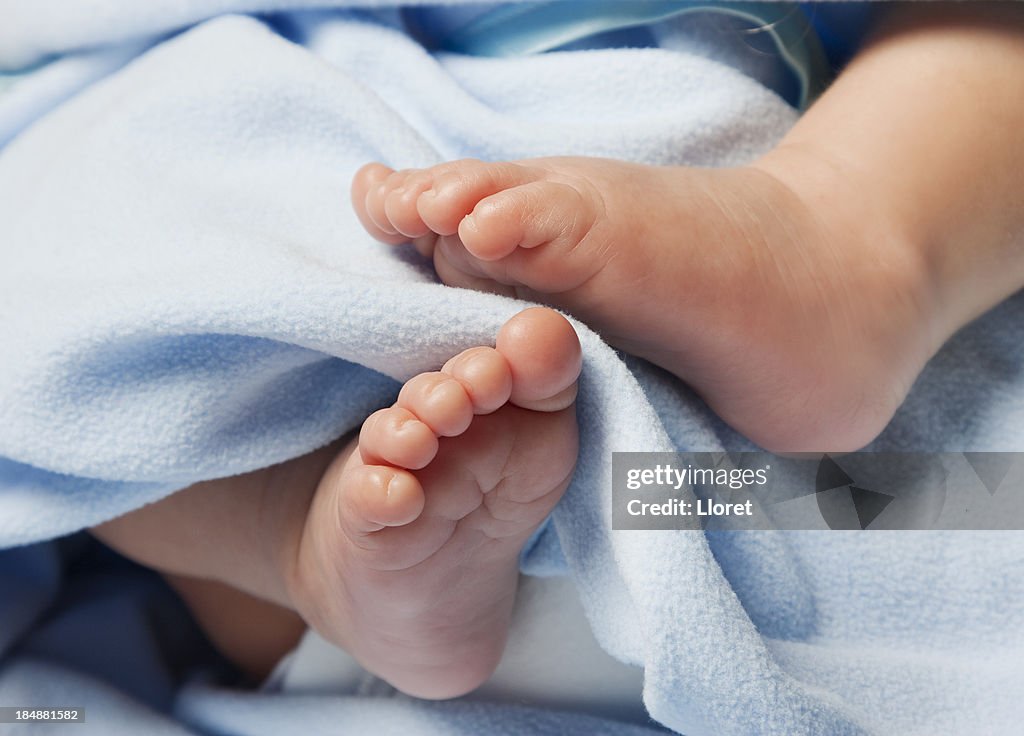 Close-up of Newborn Baby Feet with blanket