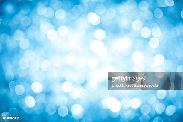 blurred blue sparkles background with darker corners and bright center. - white glitter texture stock pictures, royalty-free photos & images