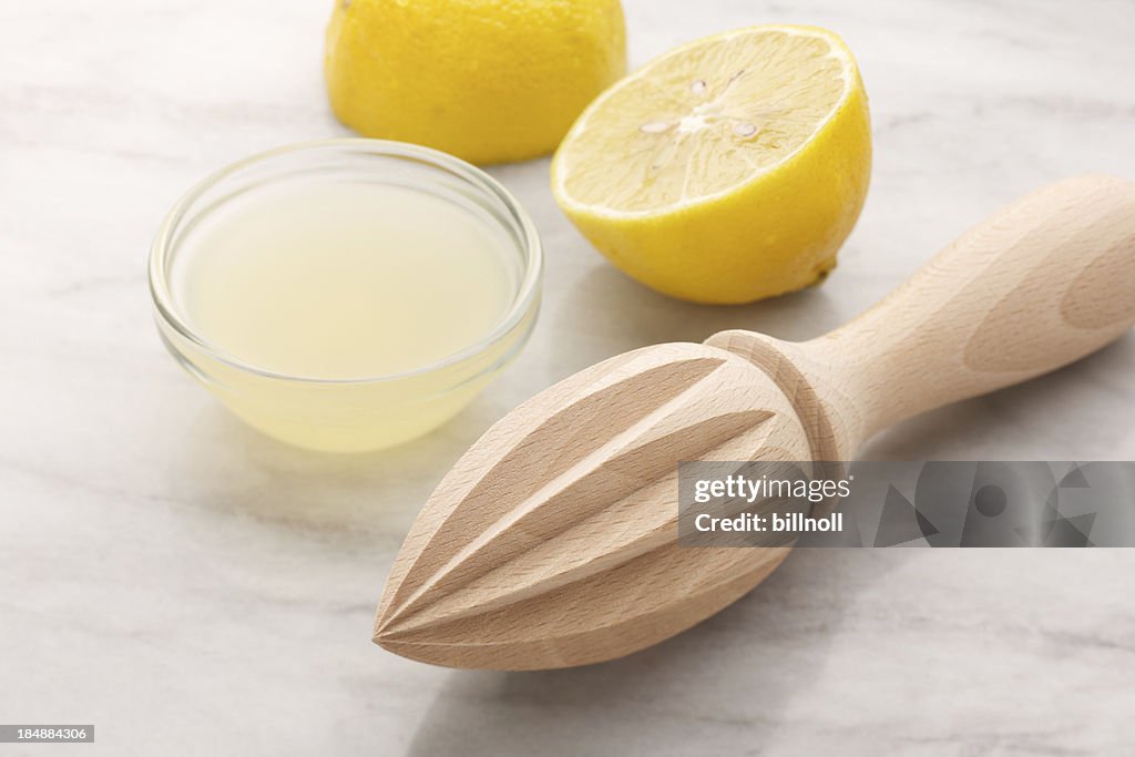 Lemon reamer with lemons and fresh juice