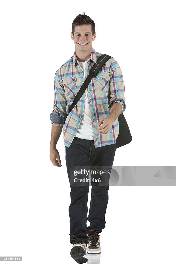 Happy university student walking