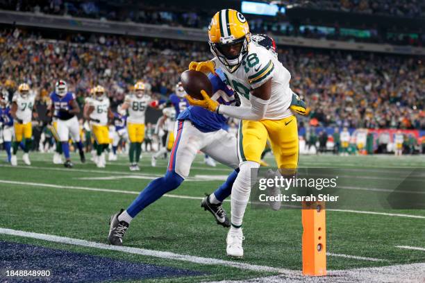 Malik Heath of the Green Bay Packers scores a touchdown against Deonte Banks of the New York Giants during the fourth quarter in the game at MetLife...