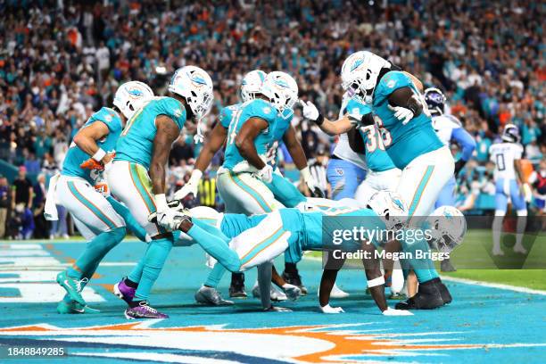 Raheem Mostert of the Miami Dolphins celebrates with teammates after a rushing touchdown in the fourth quarter against the Tennessee Titans at Hard...