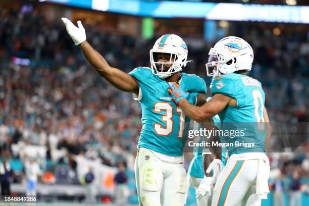 Raheem Mostert of the Miami Dolphins celebrates a touchdown in the fourth quarter against the Tennessee Titans at Hard Rock Stadium on December 11,...