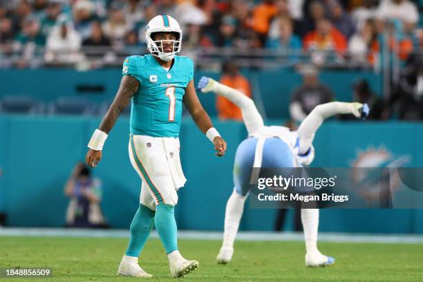 Tua Tagovailoa of the Miami Dolphins reacts in the fourth quarter against the Tennessee Titans at Hard Rock Stadium on December 11, 2023 in Miami...