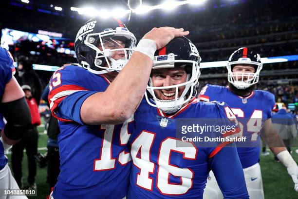 Tommy DeVito and Randy Bullock of the New York Giants celebrate after defeating the Green Bay Packers in the game at MetLife Stadium on December 11,...