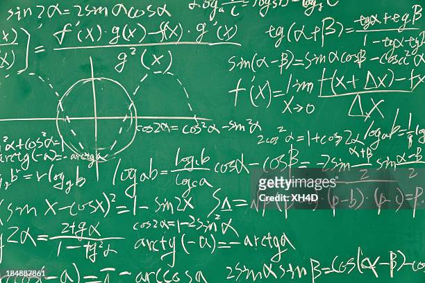 mathematical formula on green blackboard - physics equation stock pictures, royalty-free photos & images