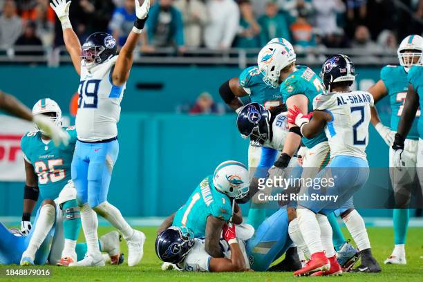 Harold Landry III of the Tennessee Titans sacks Tua Tagovailoa of the Miami Dolphins in the fourth quarter at Hard Rock Stadium on December 11, 2023...