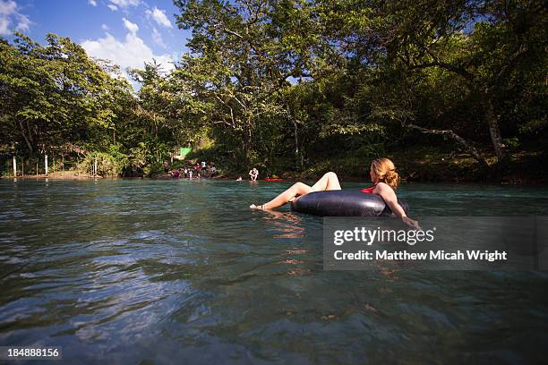 floating down river in an inner tube. - river tubing stock pictures, royalty-free photos & images