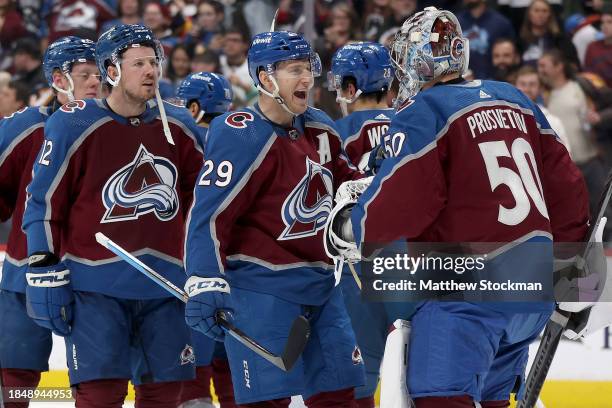 Nathan MacKinnon of the Colorado Avalanche celebrates with goalie Ivan Prosvetov after their win against the Calgary Flames at Ball Arena on December...