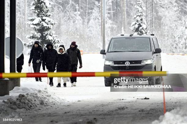 Migrants arrive at the Vaalimaa border check point between Finland and Russia in Virolahti, Finland on December 15, 2023. The check point was...