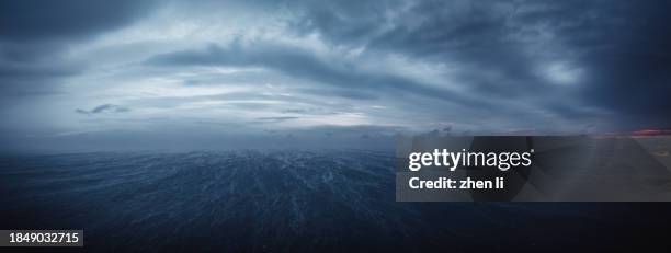 snowflakes dancing over the sea - dramatic night sky stock pictures, royalty-free photos & images