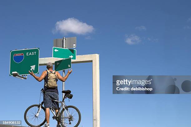 lost man on a bike - one way stock pictures, royalty-free photos & images