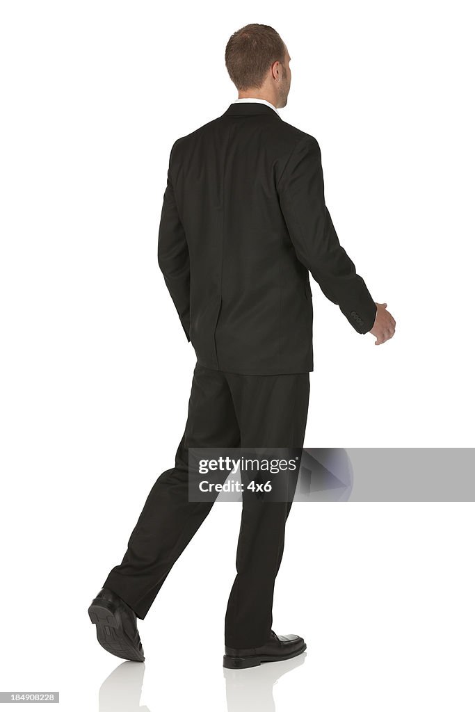 Rear view of a businessman walking