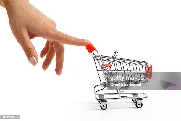 small shopping cart been pushed - shopping trolleys stockfoto's en -beelden