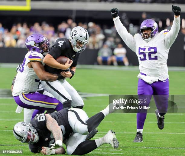 Linebacker D.J. Wonnum of the Minnesota Vikings sacks quarterback Aidan O'Connell of the Las Vegas Raiders as defensive tackle Sheldon Day of the...