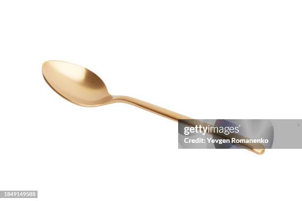 golden spoon isolated on white background - theelepel stockfoto's en -beelden